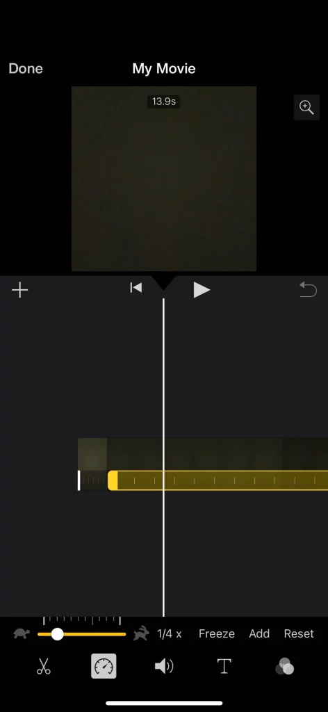 iMovie timeline on iPhone showing speed adjustment slider at 1/4x, teaching how to slow down regular videos without losing quality using iMovie.