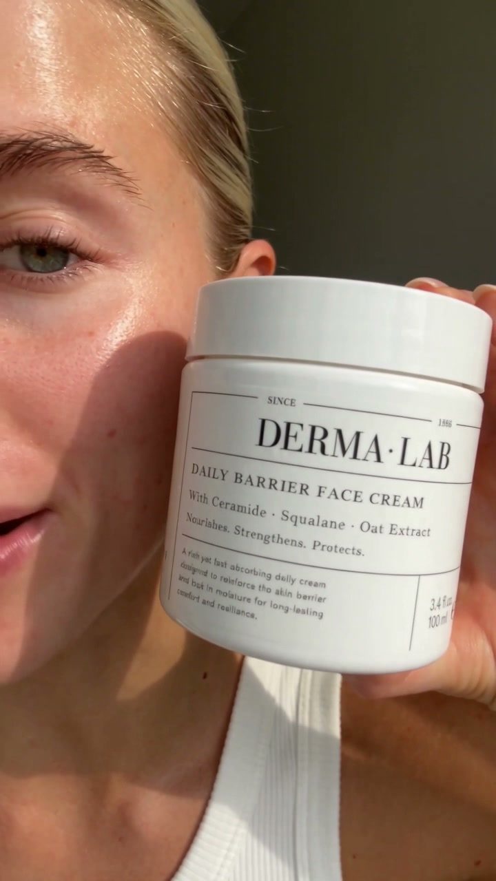 Final frame from the AI-generated moisturizer UGC video showing a woman holding the jar beside her face
